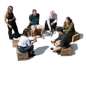 cut out group of young people sitting and talking seen from above