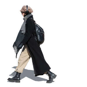 cut out woman with headphones and long black coat walking