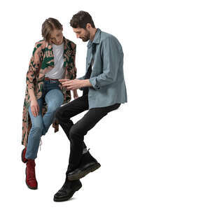 cut out man and woman sitting at a table and looking at phone