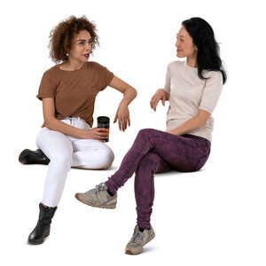 two cut out women sitting and drinking coffee and talking