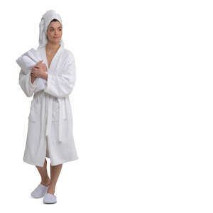 cut out woman in a white spa bathrobe and carrying towels walking