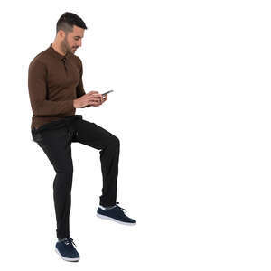 cut out man sitting on a table and looking at his phone