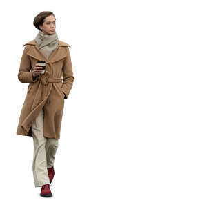 cut out woman in a brown overcoat walking and drinking coffee