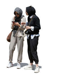 two cut out young muslim women standing and checking their phone
