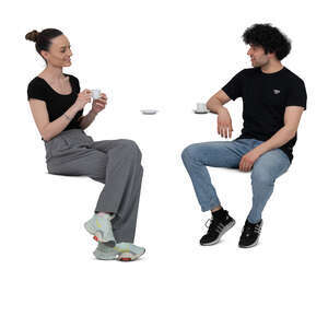 two cut out people sitting in a cafe and drinking coffee
