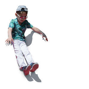cut out boy sliding down on a slide on a playground
