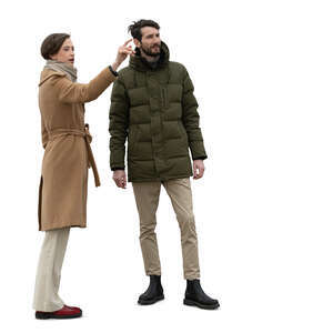 two cut out people in autumn standing outside