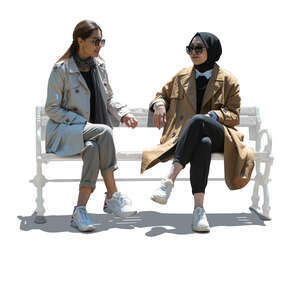 two cut out backlit muslim women sitting and talking