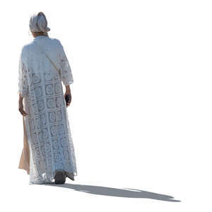 cut out backlit woman in a white long jacket and headscarf walking