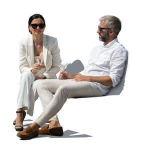 cut out man and woman sitting and drinking martini cocktails