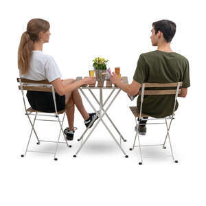 cut out man and woman sitting in a cafe seen from back angle
