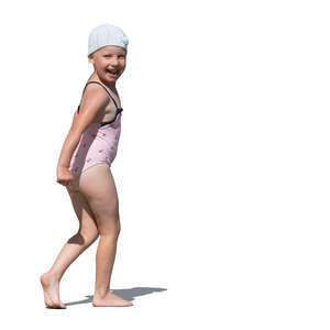 cut out small girl in a swimsuit walking happily on the beach