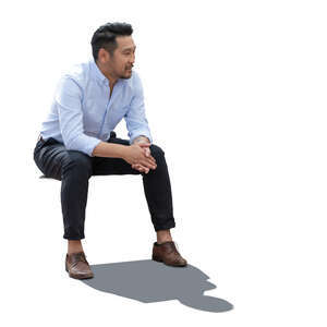 backlit asian man sitting