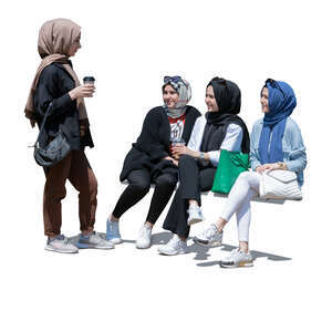 four muslim girls sitting and chatting