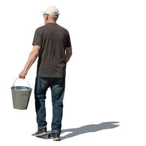 older man with a bucket walking in the garden