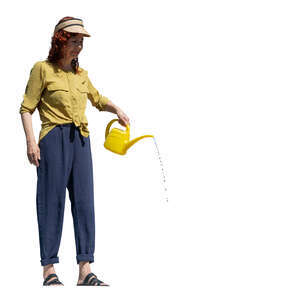 woman standing on a balcony and watering plants