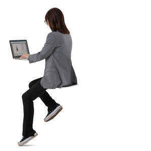 woman working with a computer sitting at a counter table