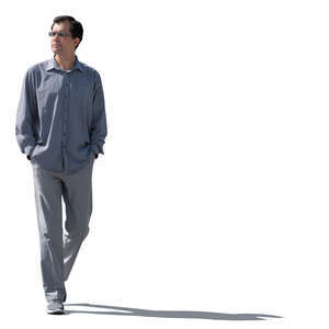 sidelit man walking hands in his pockets