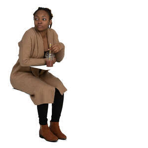 woman sitting and drinking juice and looking around