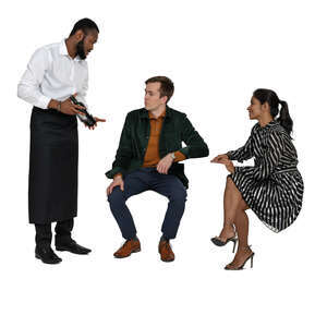 waiter serving wine to two people sitting at a restaurant table