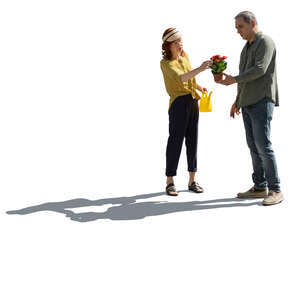 backlit older couple going to plant some flowers in the garden