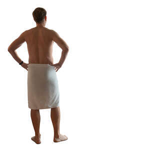 man in a sauna towel standing and looking out of the window