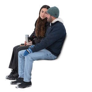two cut out people sitting outside in winter and drinking hot tea