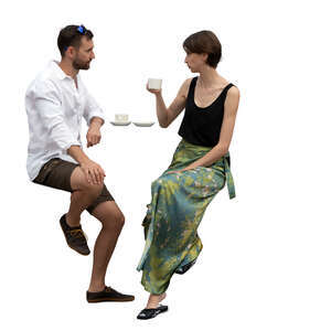 man and woman sitting at a bar table and drinking coffee