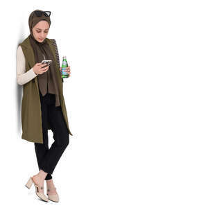 muslim woman standing and leaning against the wall