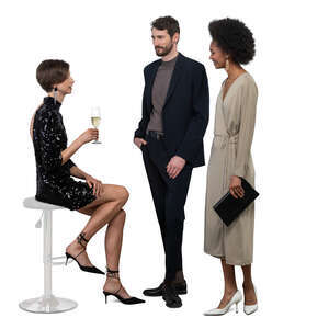 woman sitting and drinking champagne and talking to two friends at a party