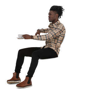 black man sitting a cafe and drinking coffee