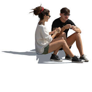 man and woman sitting on the sidewalk and eating ice cream