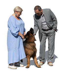 man and woman with a german shepard standing