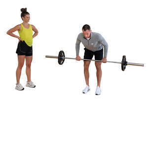 man lifting weights and woman standing by
