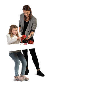 cut out little girl knitting with the help of a teacher