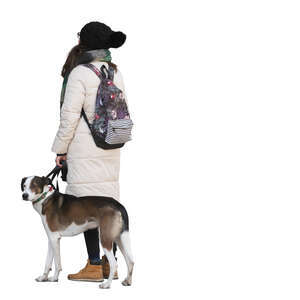 woman in winter with a dog standing and looking up