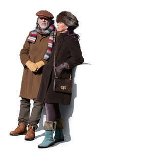 older couple standing outside on a balcony in winter