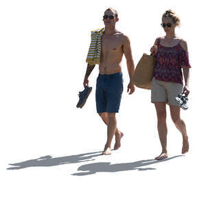 backlit man and woman walking barefoot in resort