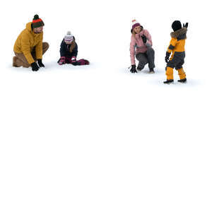 family playing with snow outside in winter