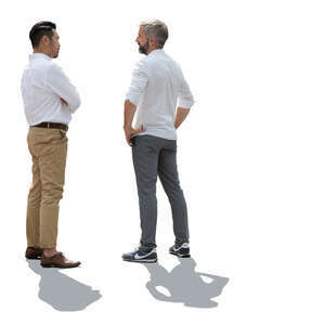 backlit men standing and talking