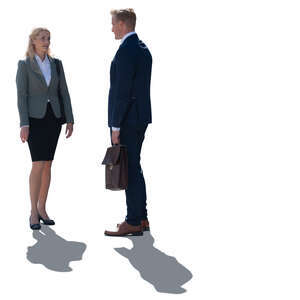 two backlit business people standing and talking