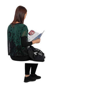 woman sitting and reading a magazine seen from back angle