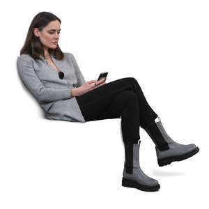 cut out woman sitting on a sofa and texting