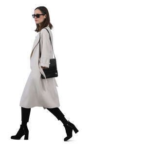 woman in a white overcoat walking