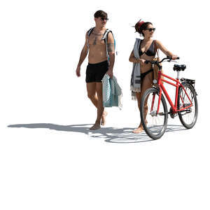 man and woman with a bike going to the beach