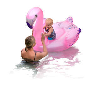 mother and her baby daughter swimming with a big pink flamingo