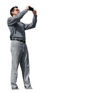 man standing and taking pictures seen from below