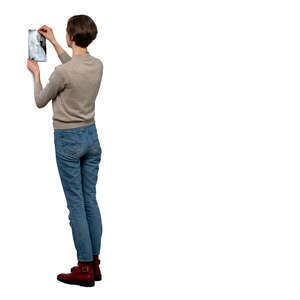woman hanging a picture up on the wall