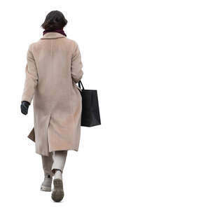woman in a light beige overcoat walking