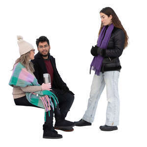 two people sitting and talking to a woman standing in front of them